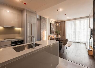 Modern kitchen with integrated appliances and adjacent dining space with natural light