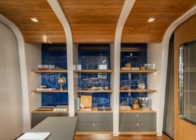 Modern home office with custom shelving and wooden ceiling