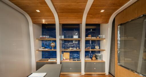 Modern home office with custom shelving and wooden ceiling