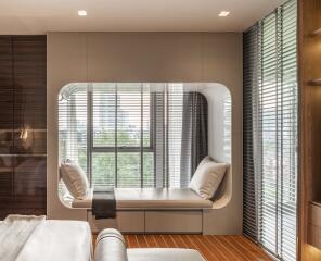 Modern bedroom with large window seating and wooden floor