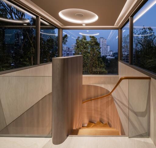 Modern staircase in a residence with large windows and city view