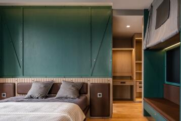 Modern bedroom with a well-designed interior, featuring a large bed, built-in shelves, and ambient lighting