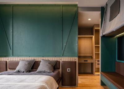 Modern bedroom with a well-designed interior, featuring a large bed, built-in shelves, and ambient lighting