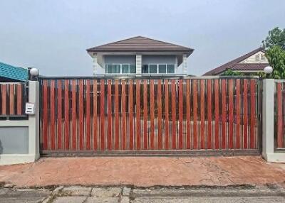 Front gate of a residential house with a clear view of the house facade.