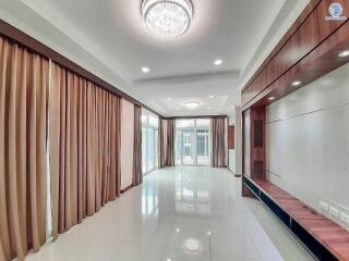 Spacious and elegant living room with modern lighting and porcelain floors