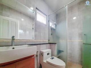 Modern bathroom with glass shower and tiled walls