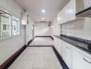 Spacious modern kitchen with white cabinetry and ample lighting