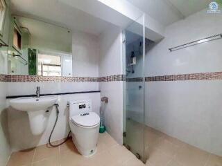 Modern bathroom with glass shower and white fixtures