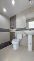 Modern tiled bathroom with toilet and sink