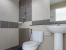 Modern tiled bathroom with toilet and sink