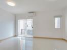 Bright and airy empty living room with tiled flooring and large windows