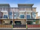 Modern residential townhouses with balconies and secure fencing