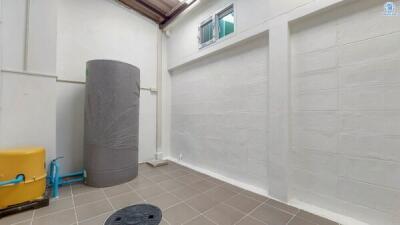 Spacious utility room with water heater and tiled flooring