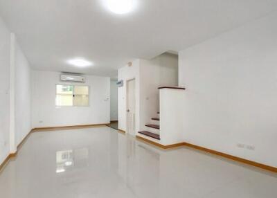 Bright and spacious interior of a modern building, showing a room with glossy tiled floor and clean white walls