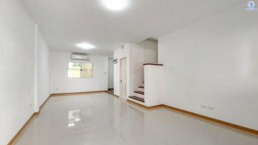 Bright and spacious interior of a modern building, showing a room with glossy tiled floor and clean white walls