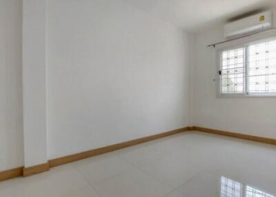 Spacious and well-lit empty bedroom with a window
