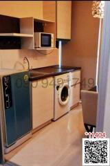 Compact kitchen with modern appliances and washing machine
