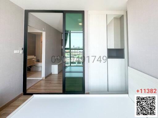 Modern bedroom interior with balcony access and sliding glass doors