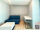 Compact living room with blue sofa and white furniture