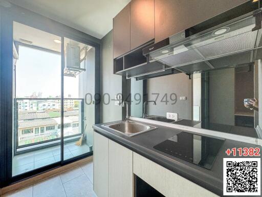 Modern kitchen with stainless steel appliances and city views
