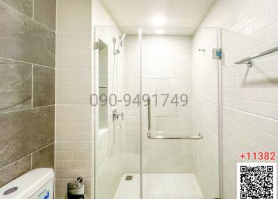 Modern bathroom with walk-in shower and white amenities