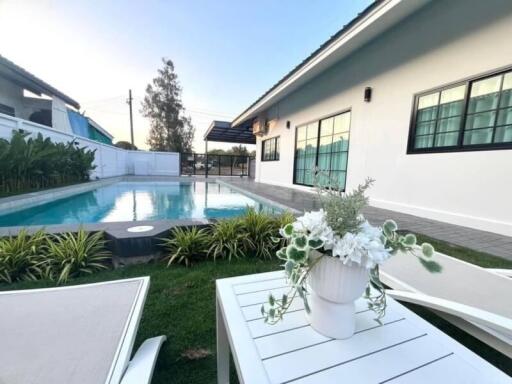 Modern house exterior with pool and patio area