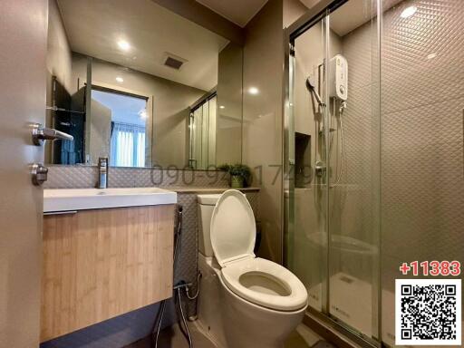 Modern bathroom with glass shower and wooden vanity