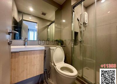 Modern bathroom with glass shower and wooden vanity