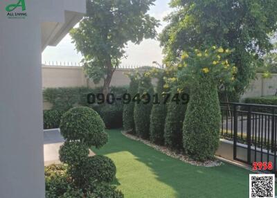 Well-manicured garden with green lawn and trimmed hedges