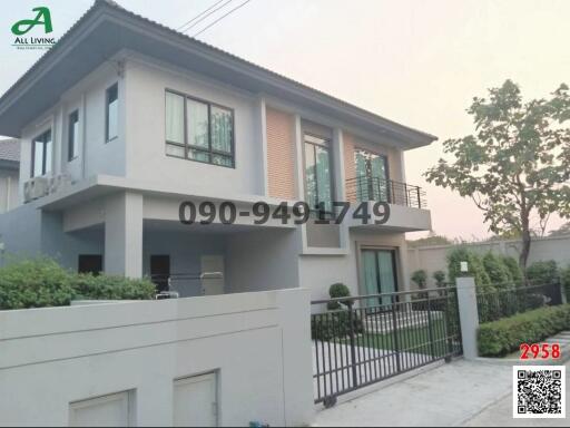 Modern two-story house with spacious balcony and gated entrance