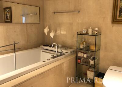 Elegant bathroom with bathtub and beige tiles