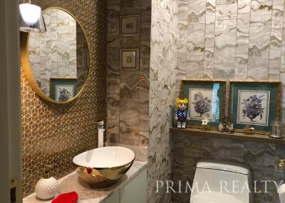 Elegant bathroom with decorative stone walls and modern fixtures