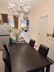 Elegant dining room with a modern chandelier and a large table