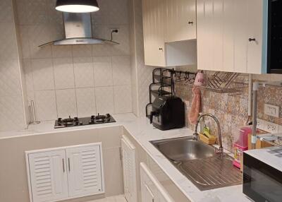 Modern kitchen with stainless steel appliances and spacious white cabinets