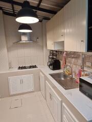 Modern kitchen with stainless steel appliances and spacious white cabinets