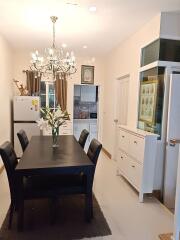 Modern dining room with chandelier and open concept to kitchen