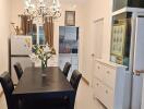 Modern dining room with chandelier and open concept to kitchen