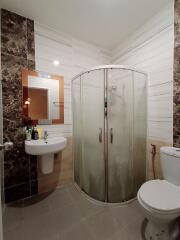 Modern bathroom interior with curved glass shower enclosure