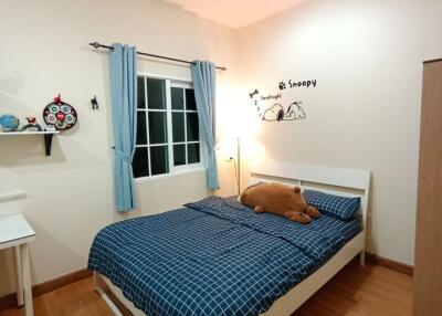 Cozy bedroom with wooden floors and Snoopy wall decorations
