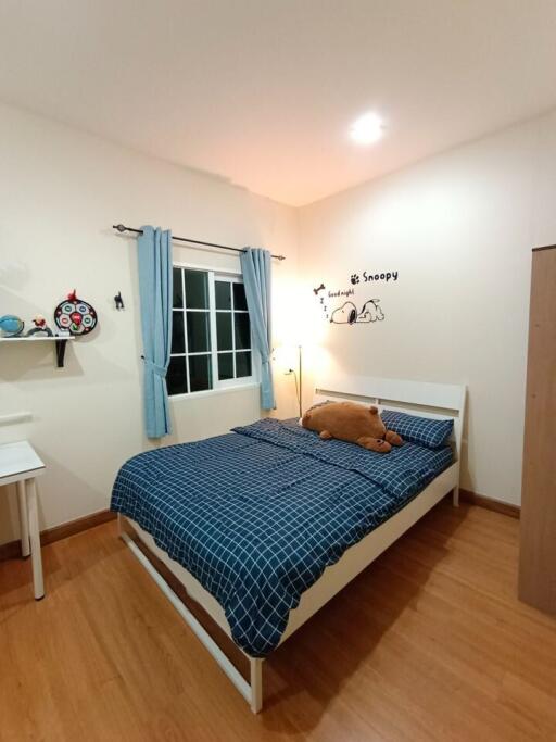 Cozy bedroom with wooden floors and Snoopy wall decorations