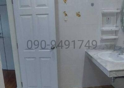 Modern bathroom interior with white fixtures and marble tiles