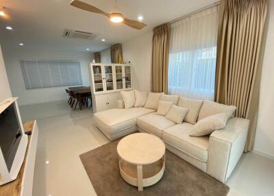 Spacious Modern Living Room with Plush Seating and Bright Lighting