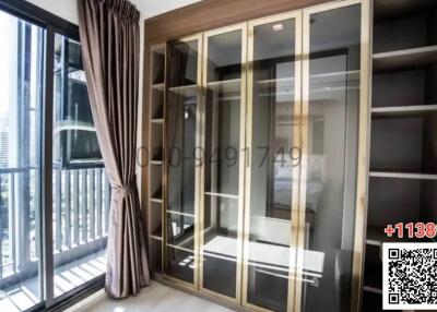 Modern bedroom with large window and built-in wardrobe