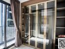 Modern bedroom with large window and built-in wardrobe