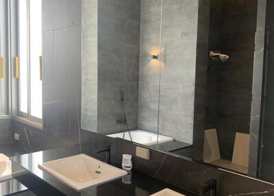 Modern bathroom interior with dual sinks and bathtub