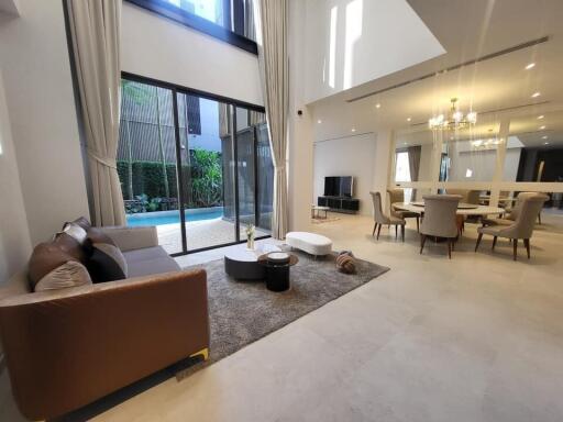 Spacious modern living room with dining area and view to the garden