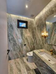 Modern bathroom with marble walls and elegant fixtures