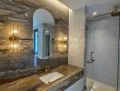 Modern bathroom with textured stone wall and sleek fixtures