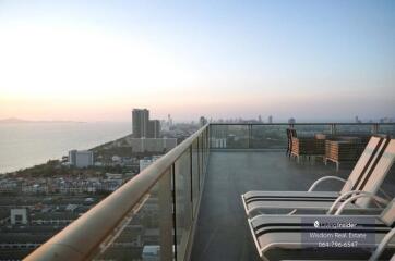 Spacious balcony with panoramic city view and outdoor seating