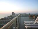 Spacious balcony with panoramic city view and outdoor seating